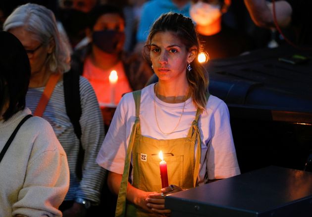 <strong>A person holds a candle during a vigil in memory of Sabina Nessa.</strong>