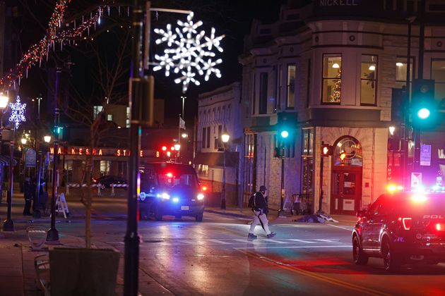 Police canvass the streets in downtown Waukesha, Wis., after a vehicle plowed into a Christmas parade on Sunday, Nov. 21, 2021. (AP Photo/Jeffrey Phelps)