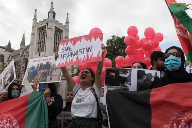 Demonstrators protest in Parliament Square against Taliban and demand human rights in Afghanistan as MPs hold a debate on the crisis.