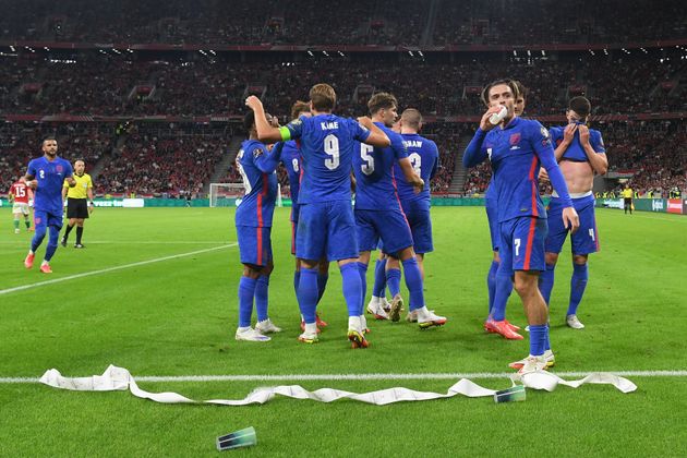 <strong>Jack Grealish drinks from a cup thrown from the crowd after Harry Maguire scores the third goal during the 2022 FIFA World Cup qualifier.</strong>