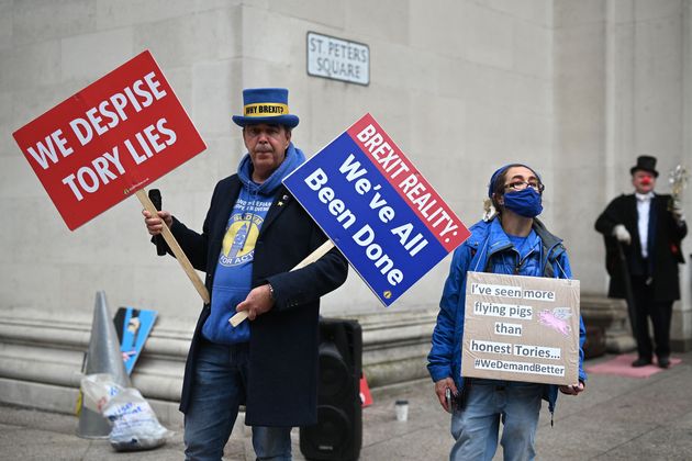 Anti-Brexit campaigner Steve Bray (L) holds placards during a protest on the sidelines of the second day of the annual Conservative Party Conference