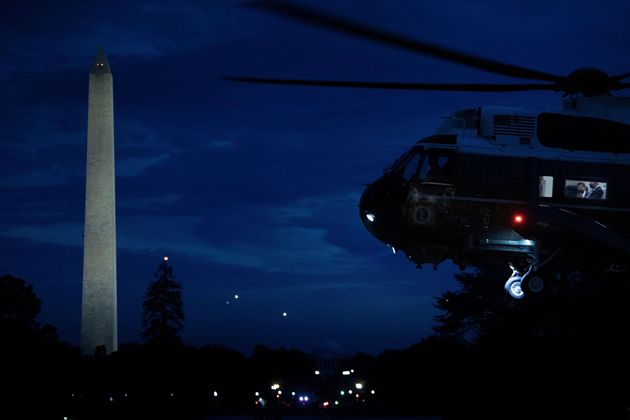 President Joe Biden is seen with staff in Marine One as it lands on the South Lawn of the White House on Oct. 7.