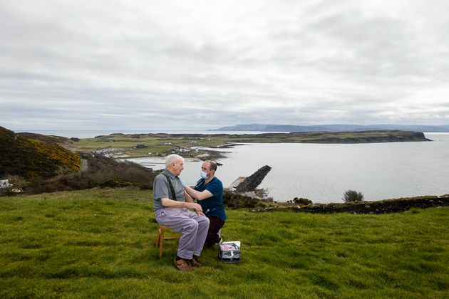 Dr Gavin Chestnutt administering a vaccine in Northern Ireland. 