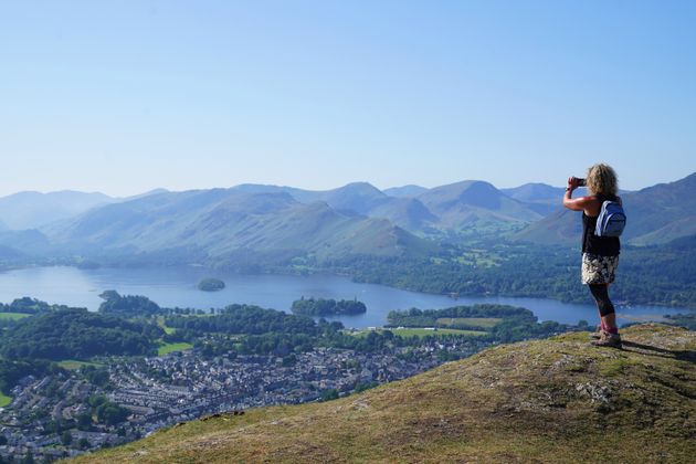 <strong>A walker takes in the view of Derwent Water in Cumbria.</strong>