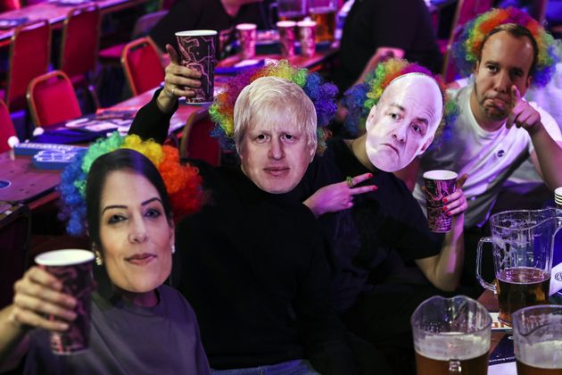 <strong>Spectators wear masks that show the faces of Priti Patel, Boris Johnson, Dominic Cummings and Matt Hancock last week.</strong>