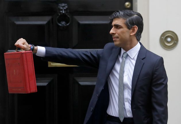 <strong>Chancellor Rishi Sunak stands with his red briefcase in front of 11 Downing Street in March.</strong>