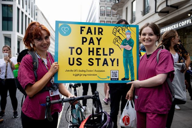 Junior doctors hold a placard outside the Department of Health and Social Care.