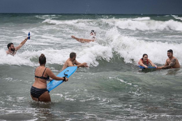 Members of a softball team play in Cocoa Beach on Wednesday as the eastern coast of central Florida braces for Hurricane Ian.