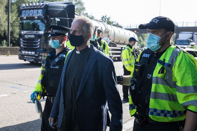 <strong>Insulate Britain climate activist Reverend Tim Hewes is arrested by Surrey Police.</strong>