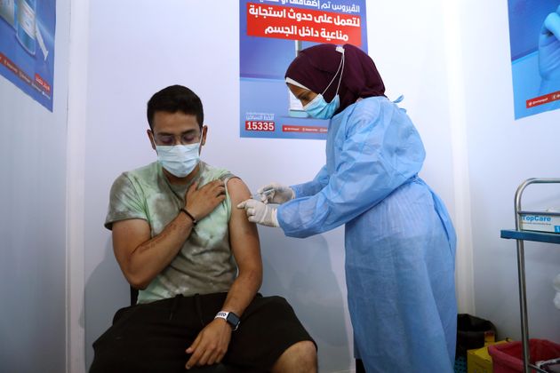 A man receives the COVID-19 vaccine at a mass vaccination venue in Cairo, Egypt. 