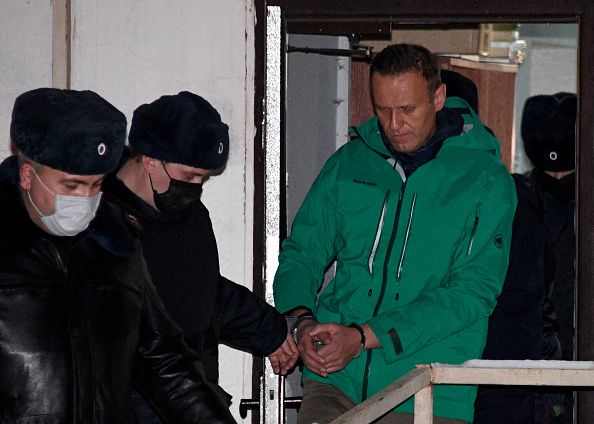 Opposition leader Alexei Navalny is escorted out of a police station on January 18, 2021