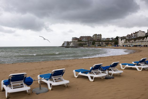 A row of sun loungers on an empty beach in Broadstairs in the UK, which has seen widespread showers, cloudy skies, and high winds – a stark contrast to the extreme heat of August 2022.