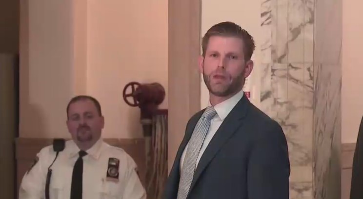 Eric Trump talks to the media after fraud trial testimony.